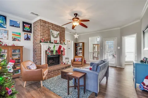 a living room with furniture a fireplace and a flat screen tv