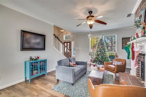 a living room with furniture a chandelier and a window
