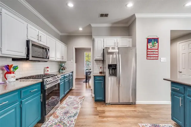 a kitchen with stainless steel appliances granite countertop a refrigerator stove and sink