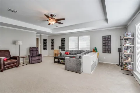 a living room with furniture and a chandelier