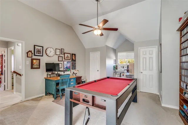 a room with pool table and a chandelier