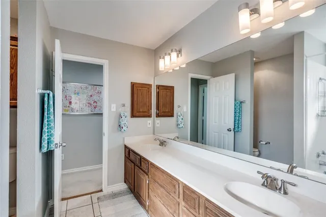 a bathroom with a double vanity sink and a mirror