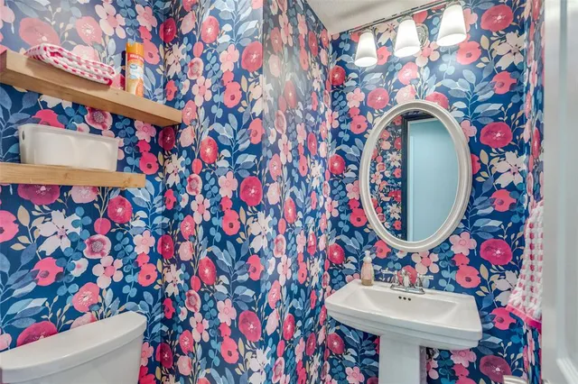 a bathroom with a sink mirror and vanity