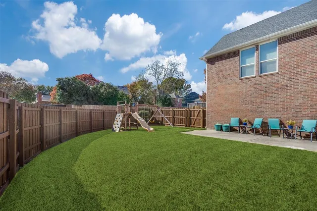 a view of a chair and table in the garden