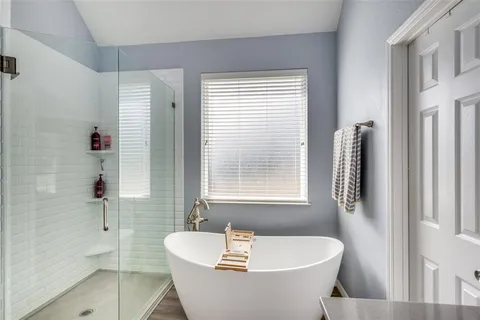 a white bath tub sitting next to a window