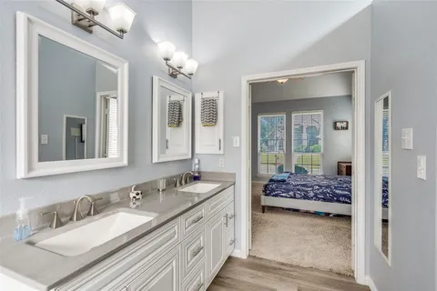 a en suite bathroom with double sink and a mirror