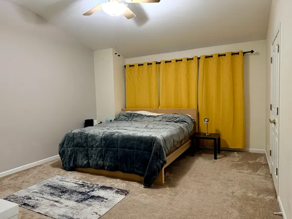 a bedroom with a bed and a window
