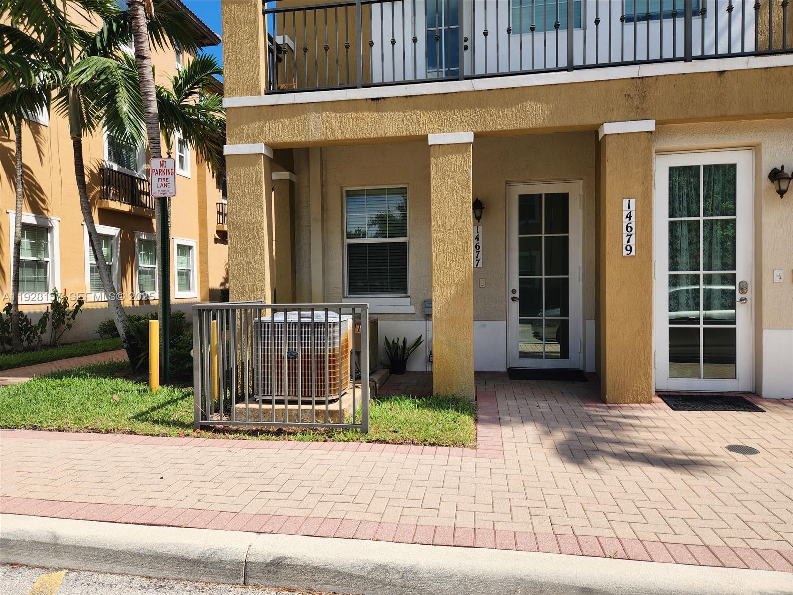 14677 Southwest 9th Street, Unit 1802 Pembroke Pines, FL 33027 - Photo 12 of 18 a front view of a house with a garden