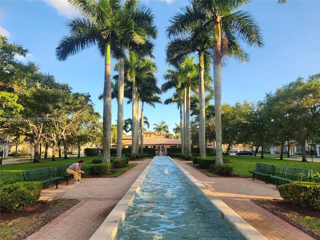 a front view of a house with palm trees