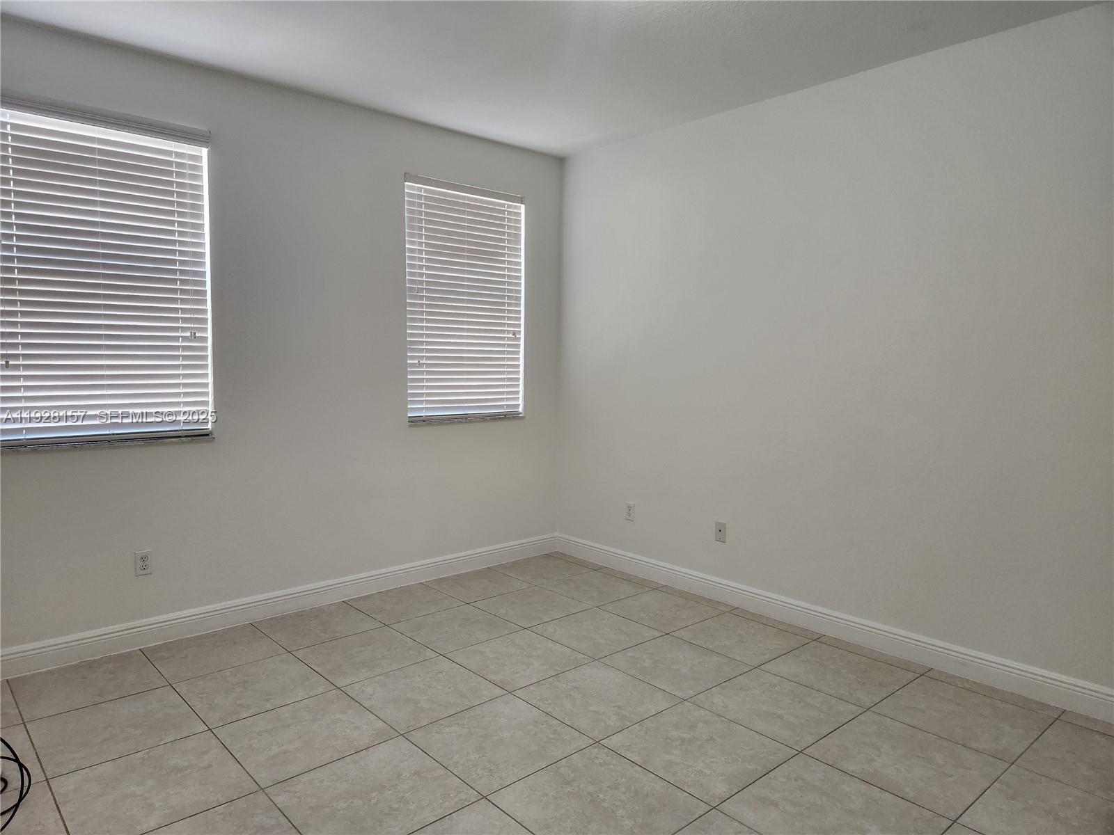 14677 Southwest 9th Street, Unit 1802 Pembroke Pines, FL 33027 - Photo 10 of 18 an empty room with a window