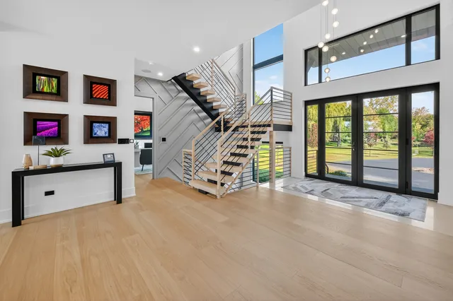 a view of a balcony with chairs and wooden floor