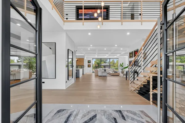 a view of entryway and hall with wooden floor