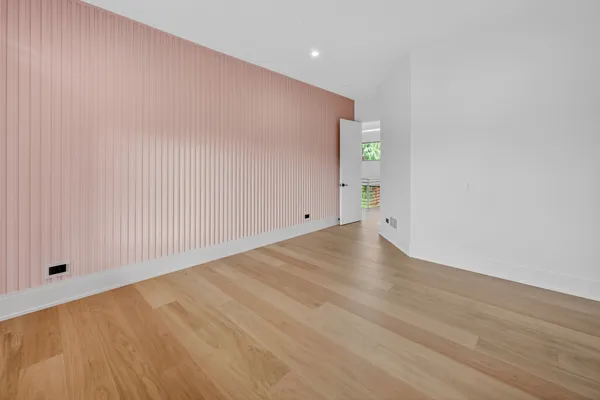 a bathroom with a granite countertop sink a toilet a mirror and shower