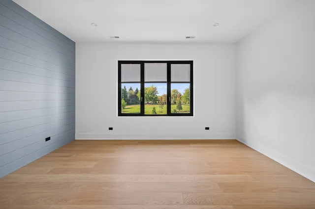 a swimming pool view with a seating space and a garden view