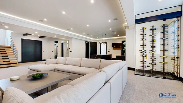 a living room with furniture kitchen and a chandelier