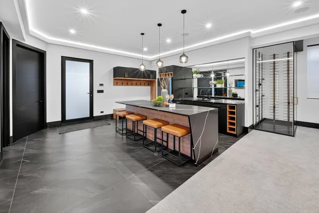 an aerial view of residential house with outdoor space and trees all around