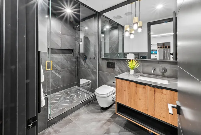 an aerial view of residential house with outdoor space and trees all around