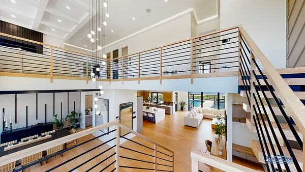 an aerial view of residential house with outdoor space and trees all around