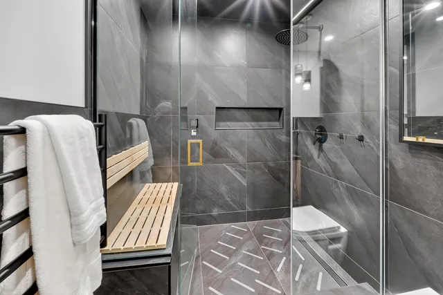 an aerial view of residential house with outdoor space and trees all around