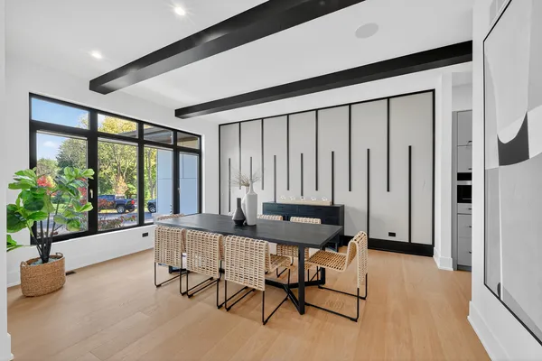 a kitchen with stainless steel appliances granite countertop a white cabinets and a chandelier
