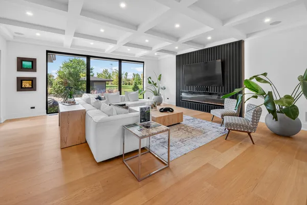 a large kitchen with stainless steel appliances a large center island attached withe living room