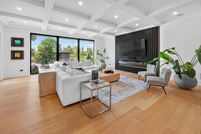 a large kitchen with stainless steel appliances a large center island attached withe living room