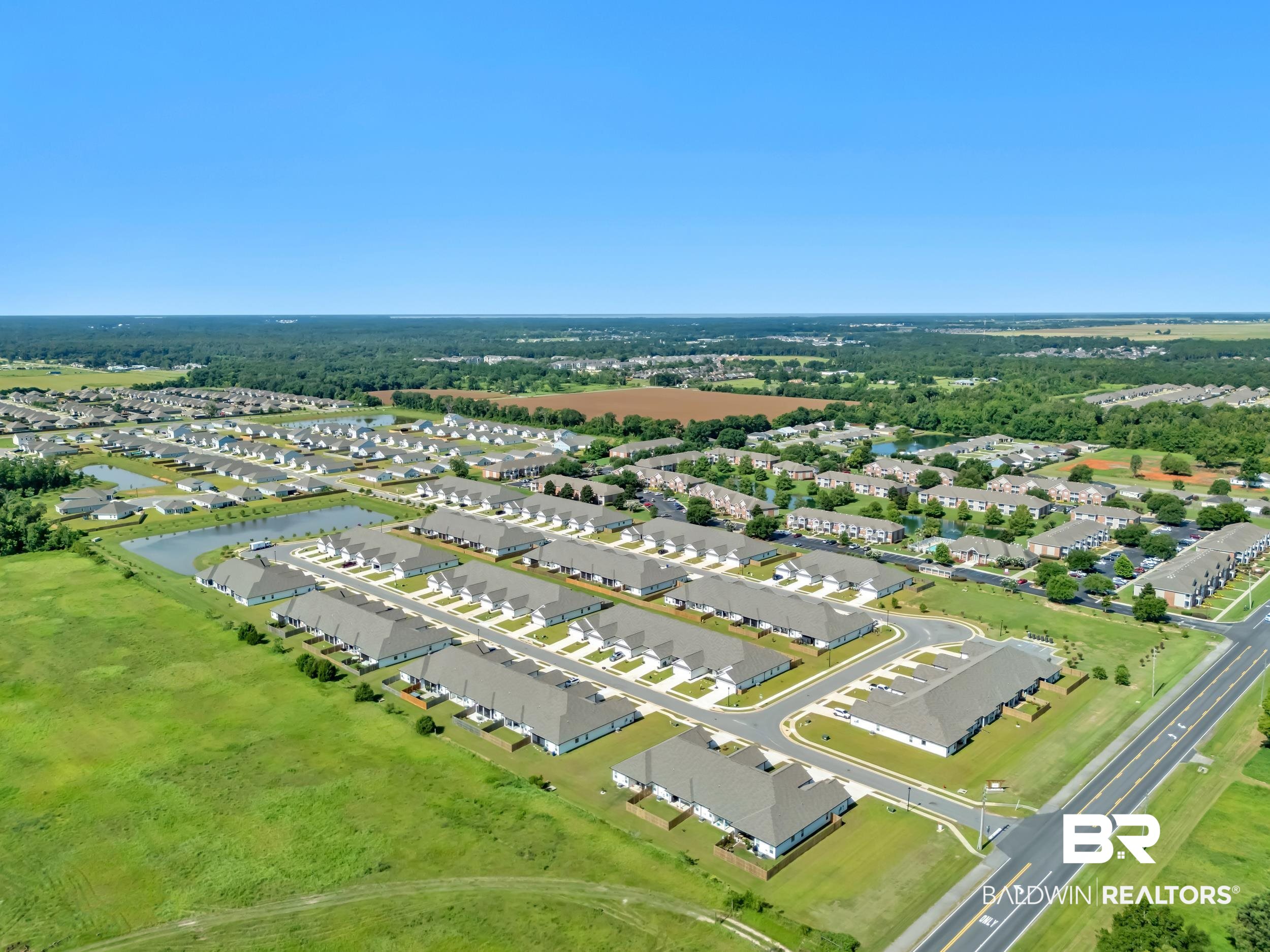 9933 Weller Cove Foley, AL 36535 - Photo 31 of 36 Aerial perspective of a developed residential community featuring multiple single-family homes and townhome-style residences