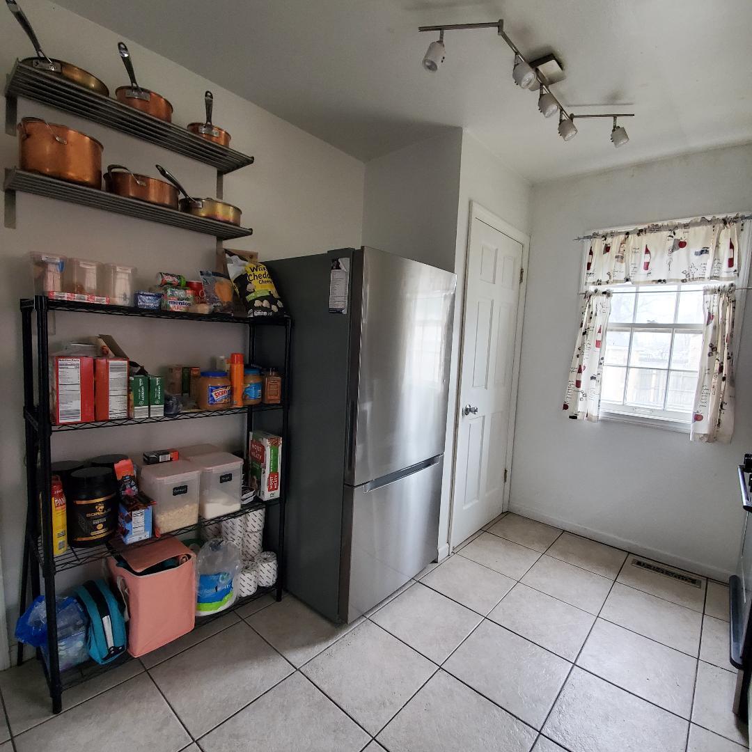 508 173rd Street Hammond, IN 46324 - Photo 17 of 61 a kitchen with stainless steel appliances a refrigerator and a window