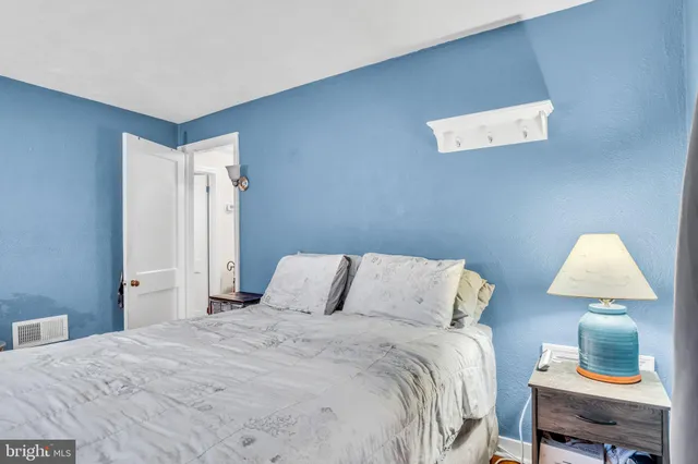 a bedroom with a bed and a lamp on table