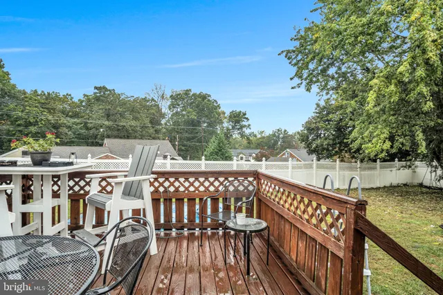 a view of a balcony with wooden chairs
