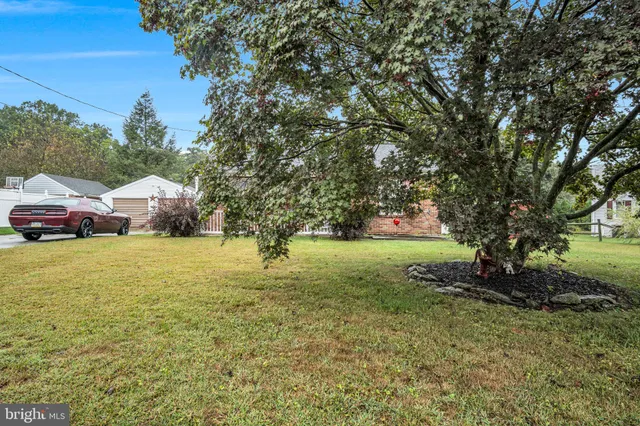 a yellow building in the middle of a yard