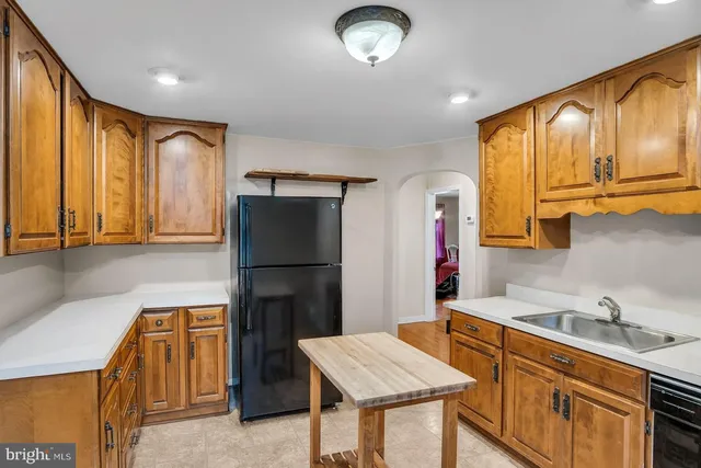 a kitchen with a refrigerator and a sink