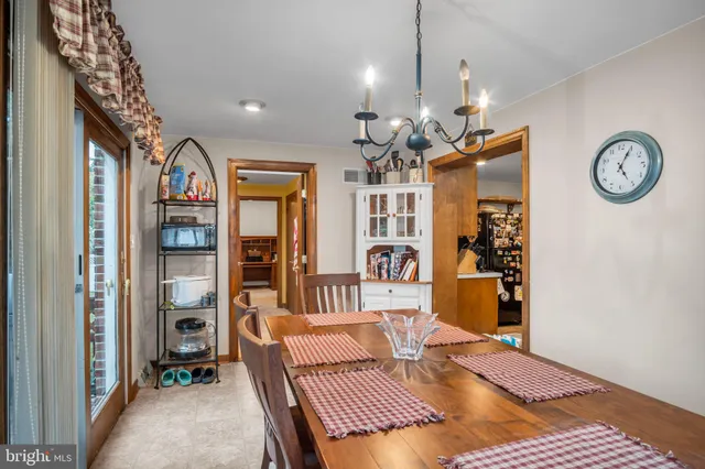 a view of a hallway with furniture and a chandelier