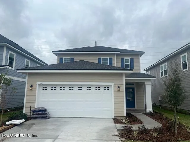 a front view of a house with garage
