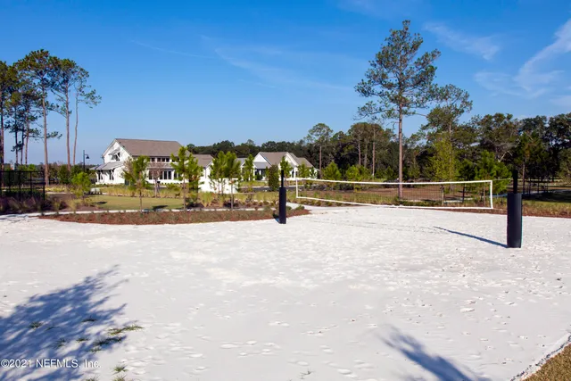 a view of backyard with swimming pool and outdoor seating