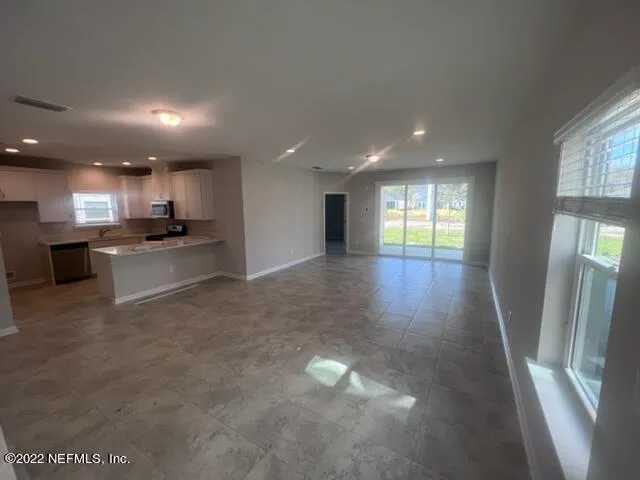 a view of a kitchen with a sink and cabinets