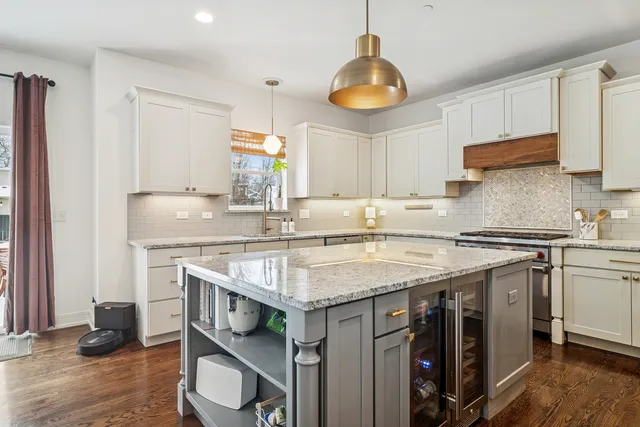a kitchen with stainless steel appliances granite countertop a stove and a sink