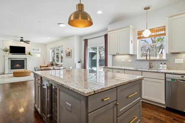 a kitchen with granite countertop a sink a counter space appliances and cabinets