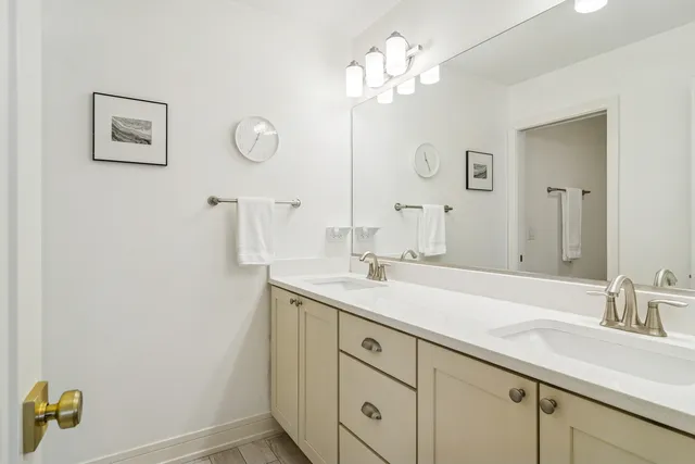 a bathroom with a sink a light fixture and a mirror