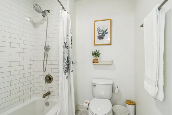 a bathroom with a toilet sink and shower