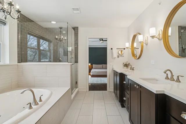 a bathroom with a tub sink and mirror