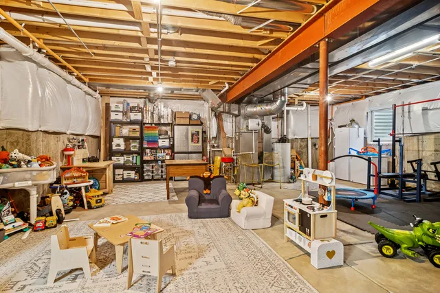 a utility room with lots of table chairs and wooden floors