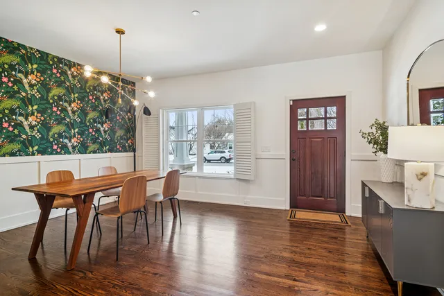 a dining room with furniture and wooden floor