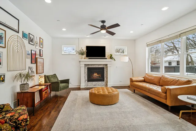 a living room with furniture a flat screen tv and a fireplace