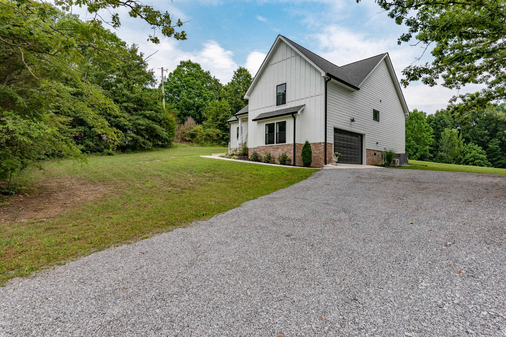519 Ab Wade Road Portland, TN 37148 - Photo 3 of 49 a view of a white house with a yard