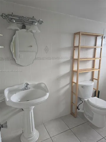 a view of an empty room with a chandelier fan