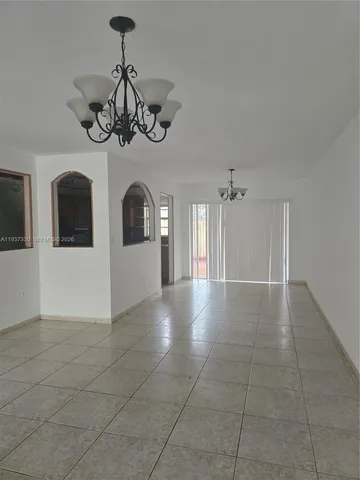 a kitchen with granite countertop a refrigerator and a stove top oven
