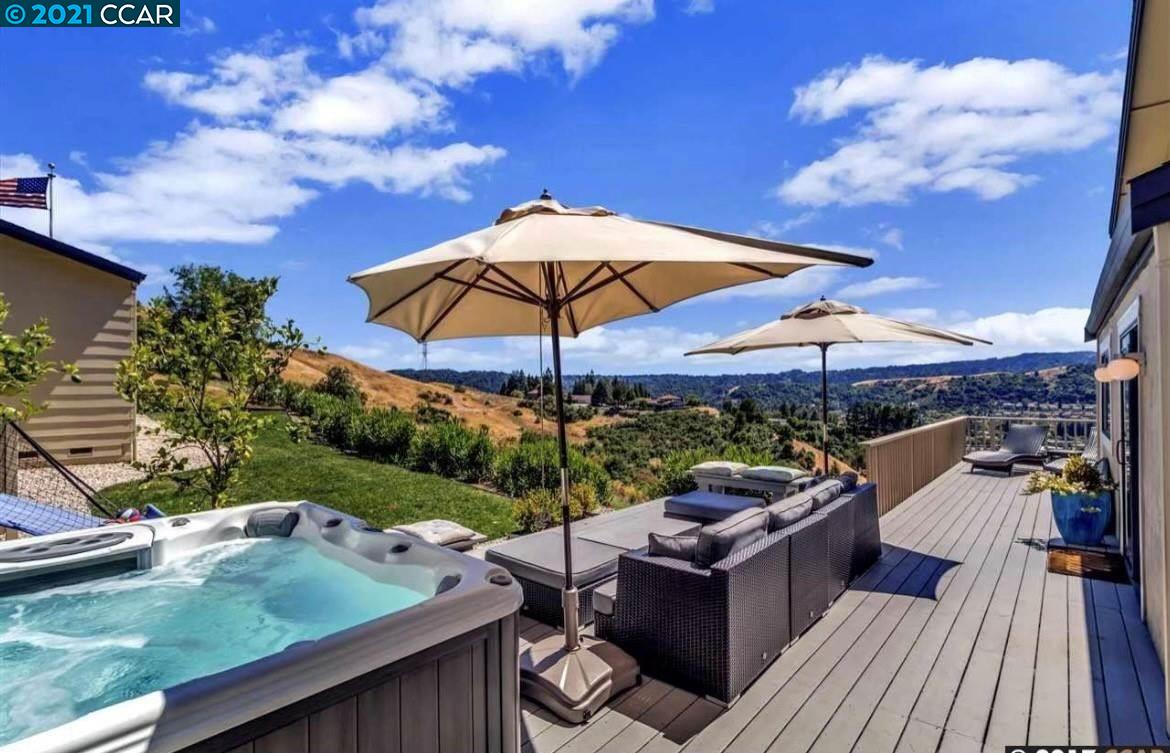1174 Alta Mesa Moraga, CA 94556 - Photo 1 of 1 a view of a roof deck with couches under an umbrella