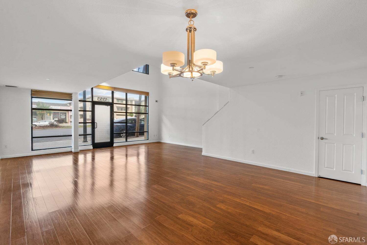 1353 El Camino Real Millbrae, CA 94030 - Photo 12 of 25 a view of a room with wooden floor chandelier and windows