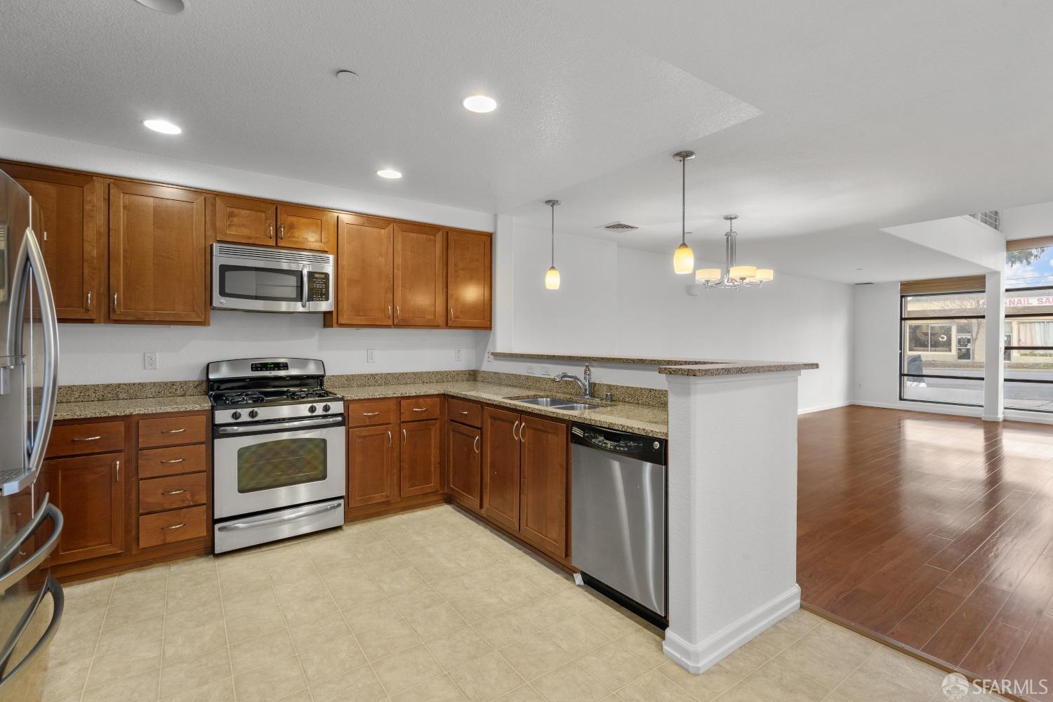 1353 El Camino Real Millbrae, CA 94030 - Photo 6 of 25 a kitchen with stainless steel appliances granite countertop a stove and a refrigerator